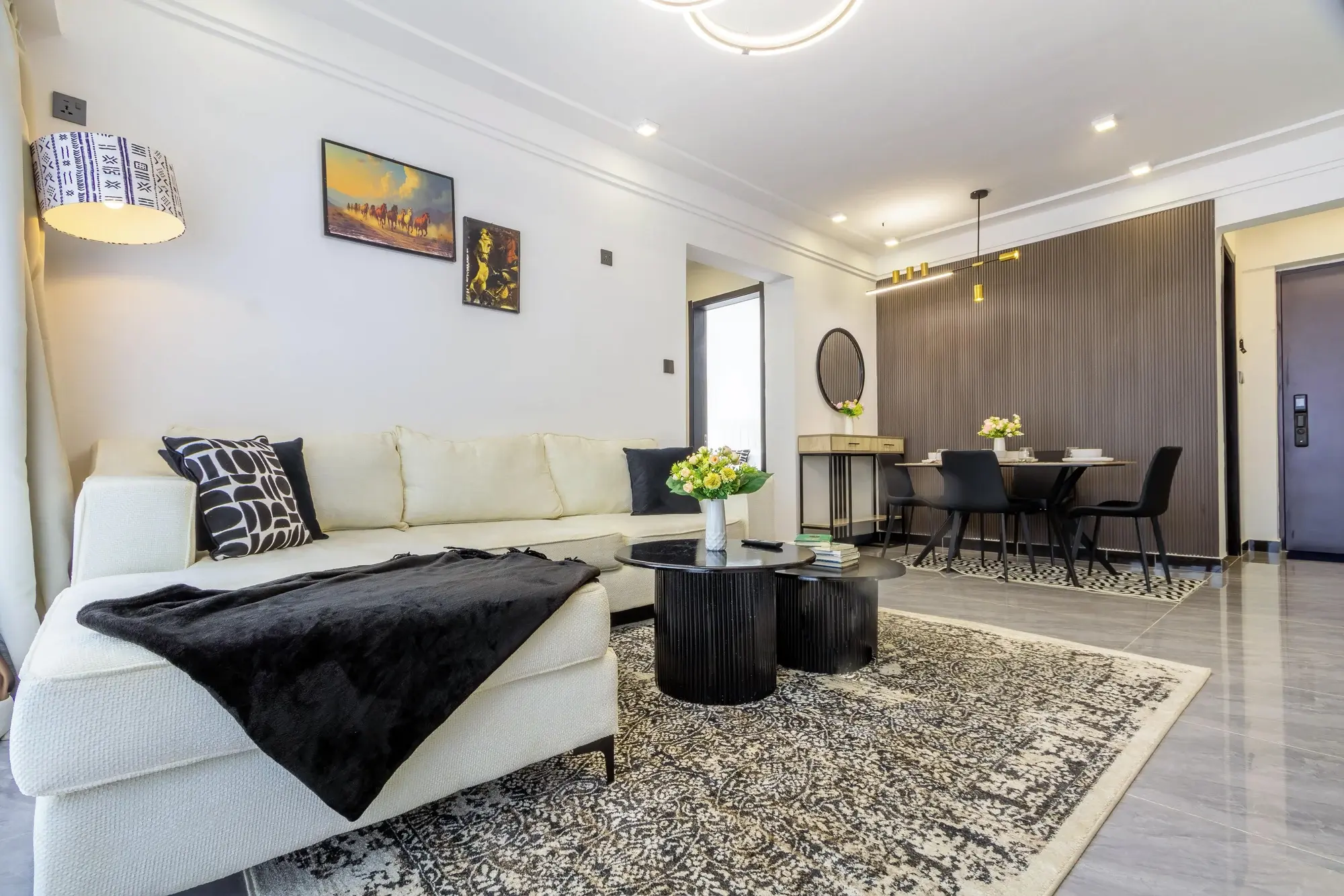Evara's living and dining space with cream seating and dark timber details