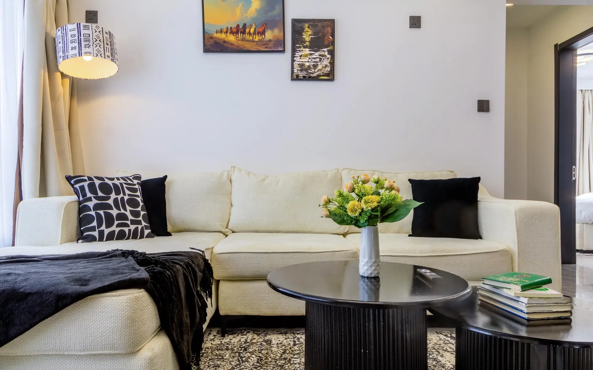 Evara living room with cream seating and black coffee tables